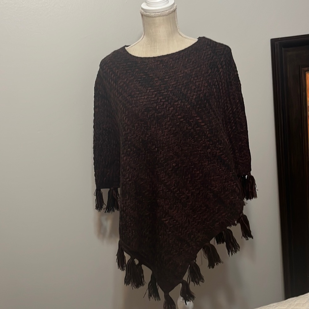 Poncho sweater weave with black and reddish brown yarn. Warm and stylish.